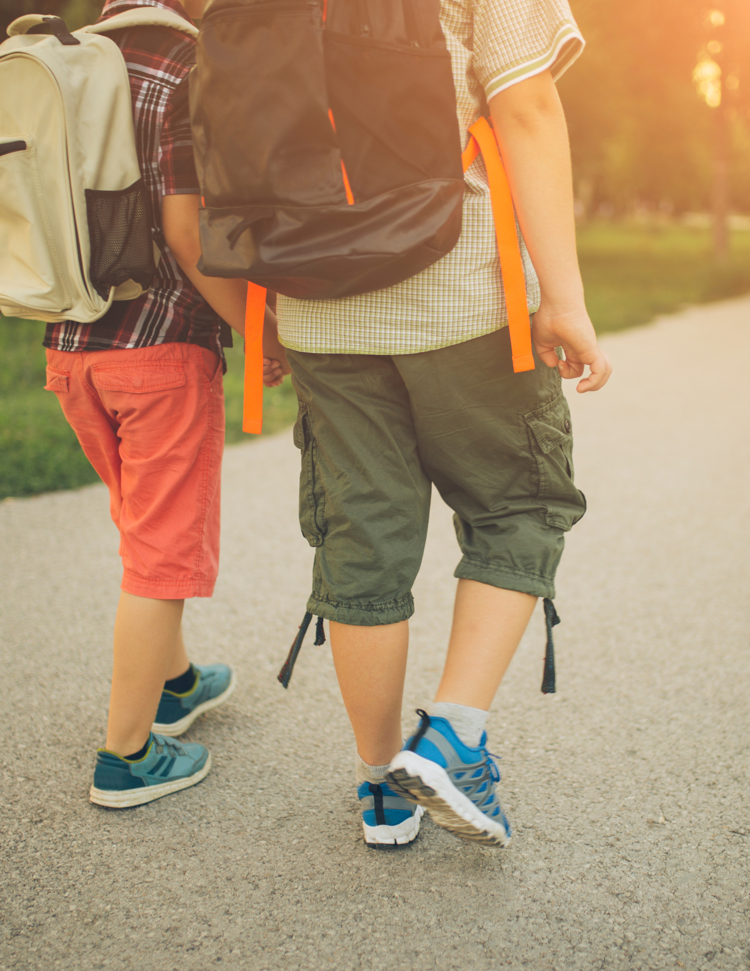 Boys walking to school along a trail